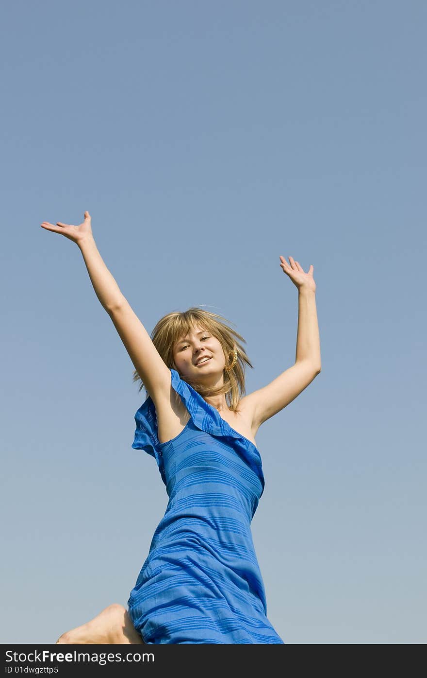 Jumping teenager on background of blue sky