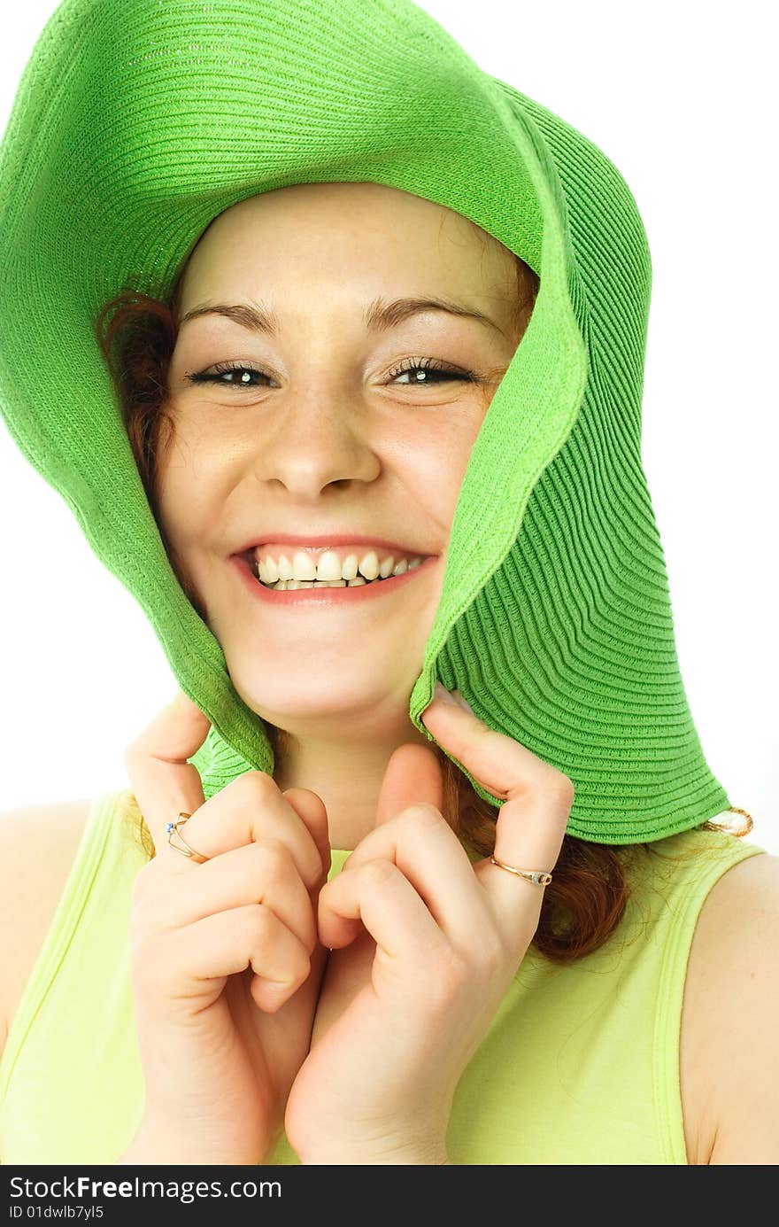 Portrait of a happy young woman with ginger hair wearing a green beach hat. Portrait of a happy young woman with ginger hair wearing a green beach hat