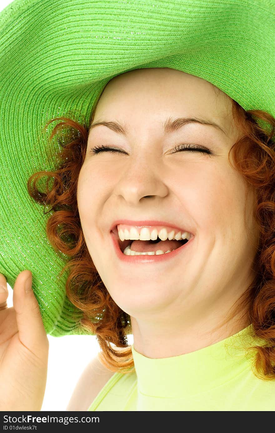 Portrait of a happy young laughing woman wearing a green beach hat. Portrait of a happy young laughing woman wearing a green beach hat