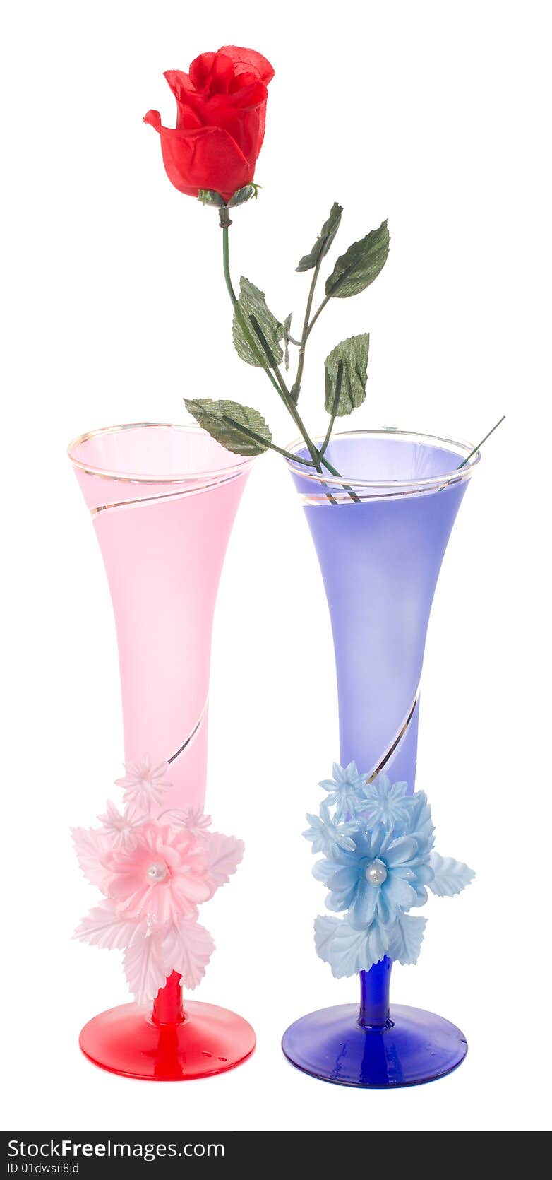 Two wedding flutes and plastic rose