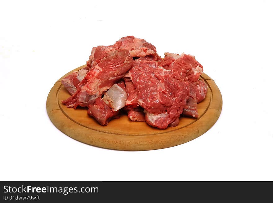 Meat pieces on wood plate