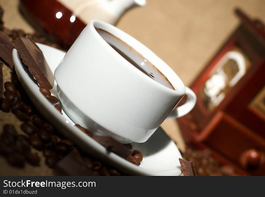 Still life with cup of coffee and coffee-mill on the sack