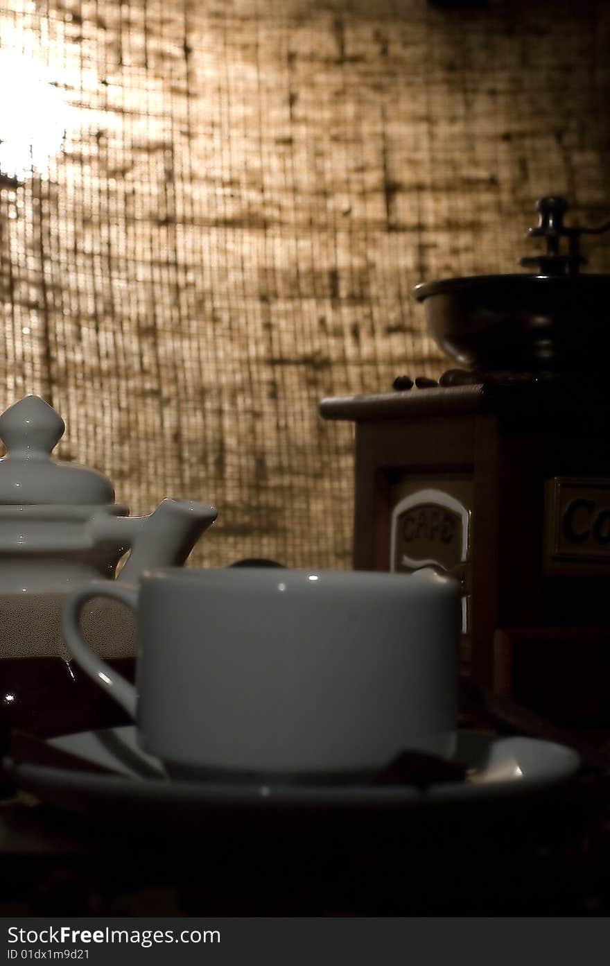 Still life with cup of coffee and coffee-mill on the sack