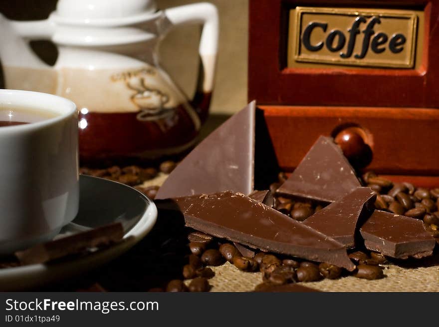 Still life with cup of coffee and coffee-mill on the sack