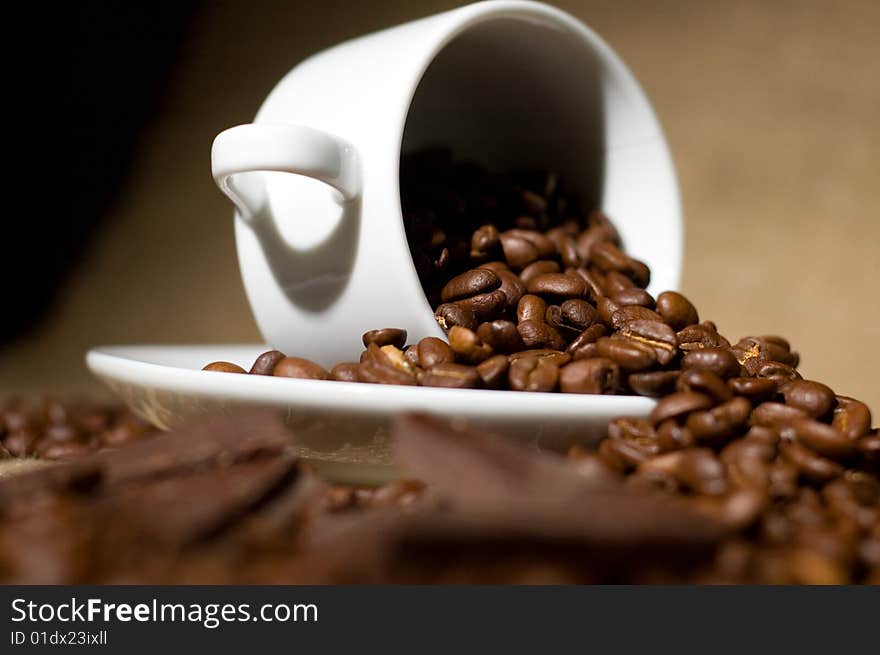 Still life with cup of coffee and coffee-beans on the sackcloth