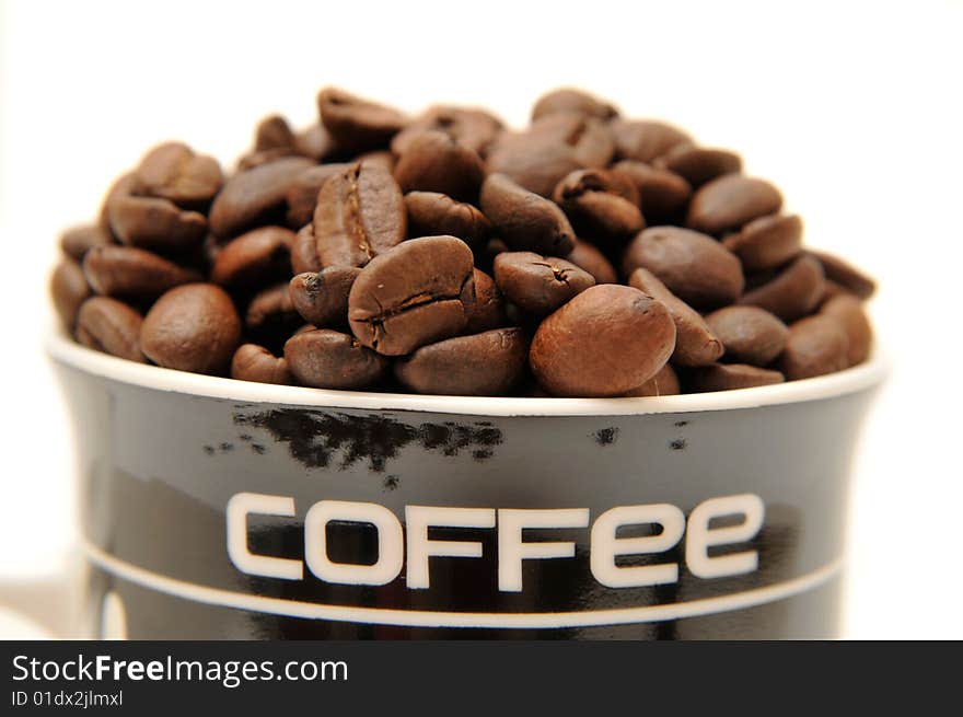 Coffee beans in the glass on white background