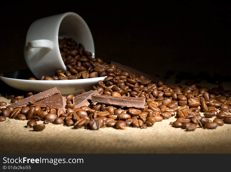 Still life with cup of coffee and coffee-beans on the sackcloth