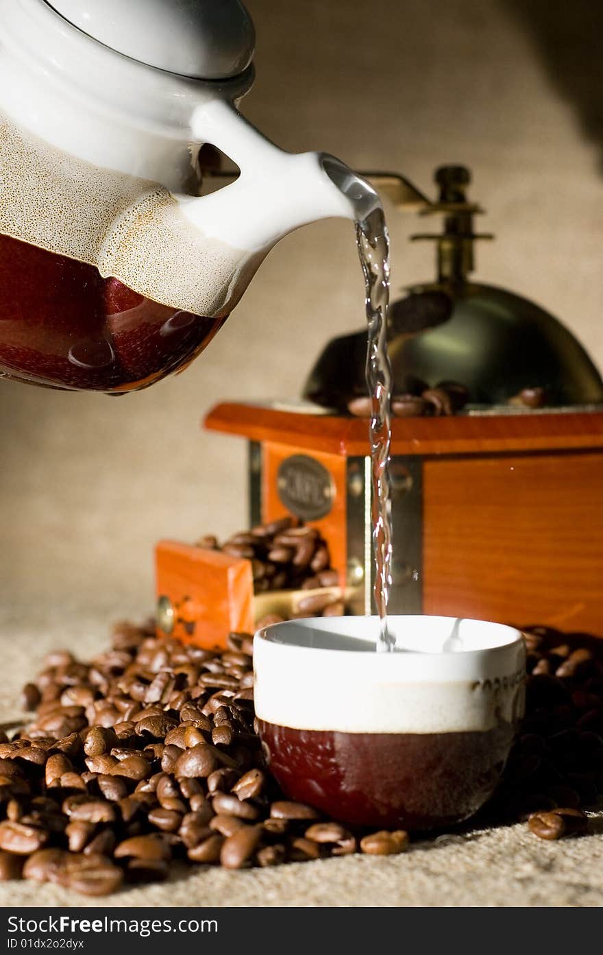 Still life of coffee grinder, coffee-pot and beans on the sack. Still life of coffee grinder, coffee-pot and beans on the sack