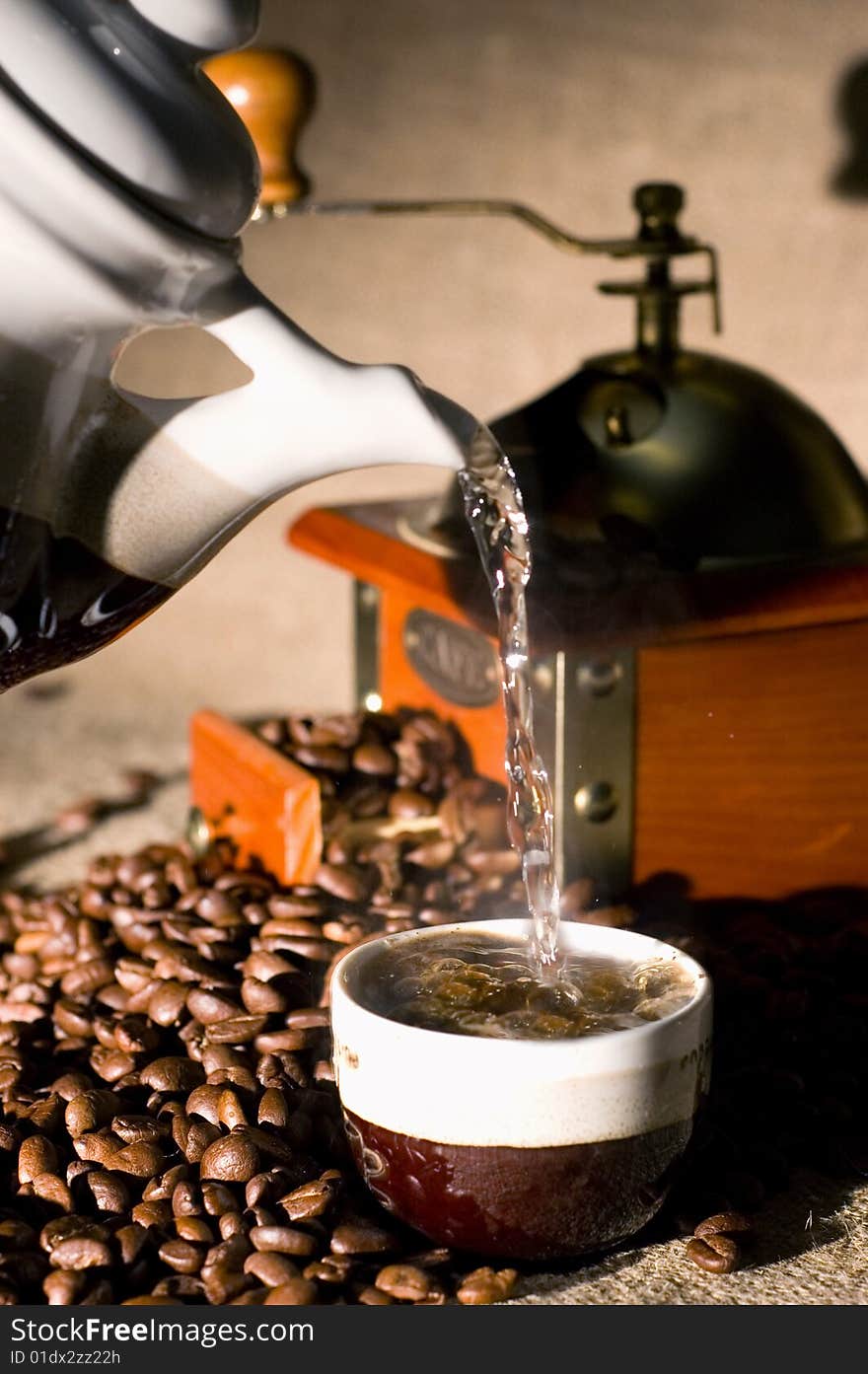 Still life of coffee grinder, coffee-pot and beans on the sack. Still life of coffee grinder, coffee-pot and beans on the sack