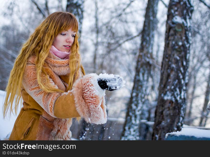 Red-heared girl in short fur coat outdoors - shallow DOF. Red-heared girl in short fur coat outdoors - shallow DOF