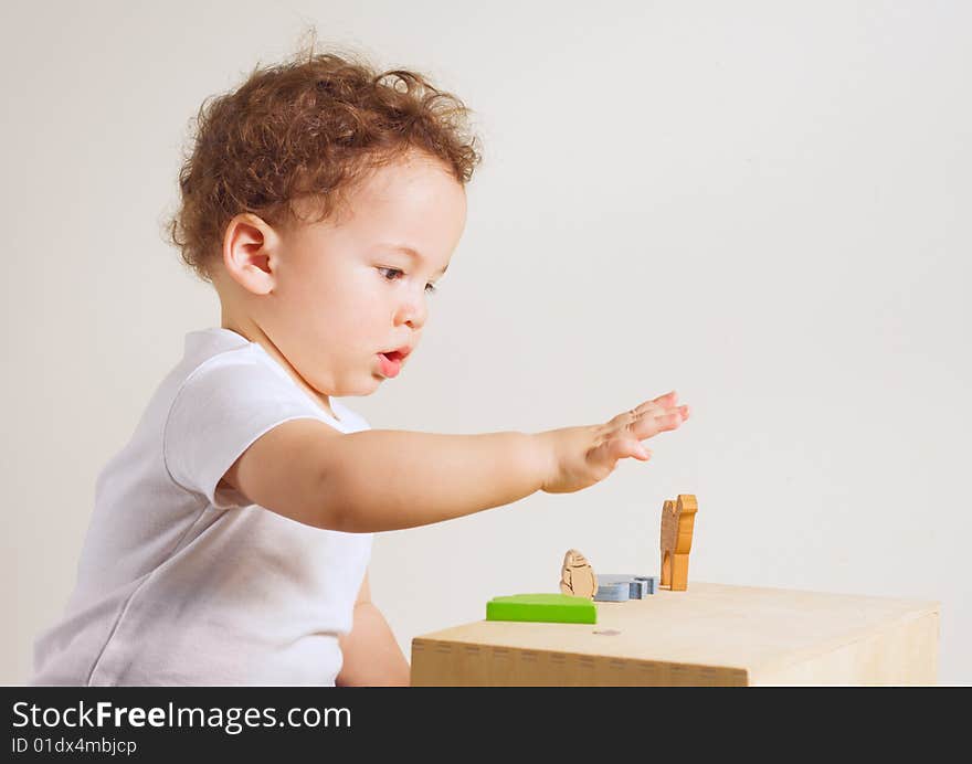 Small boy playing with colorful toys