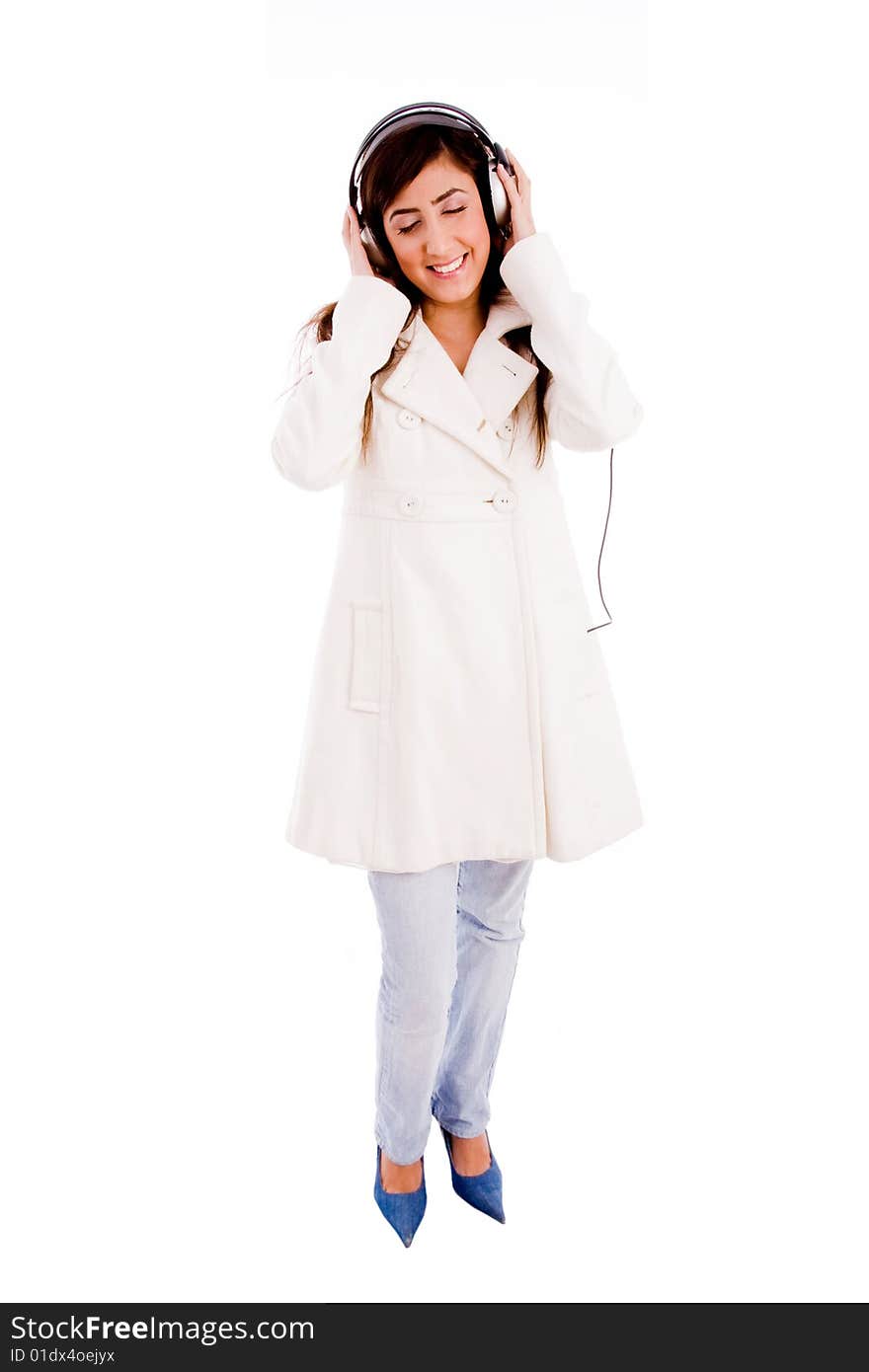 Front view of young woman enjoying music with white background