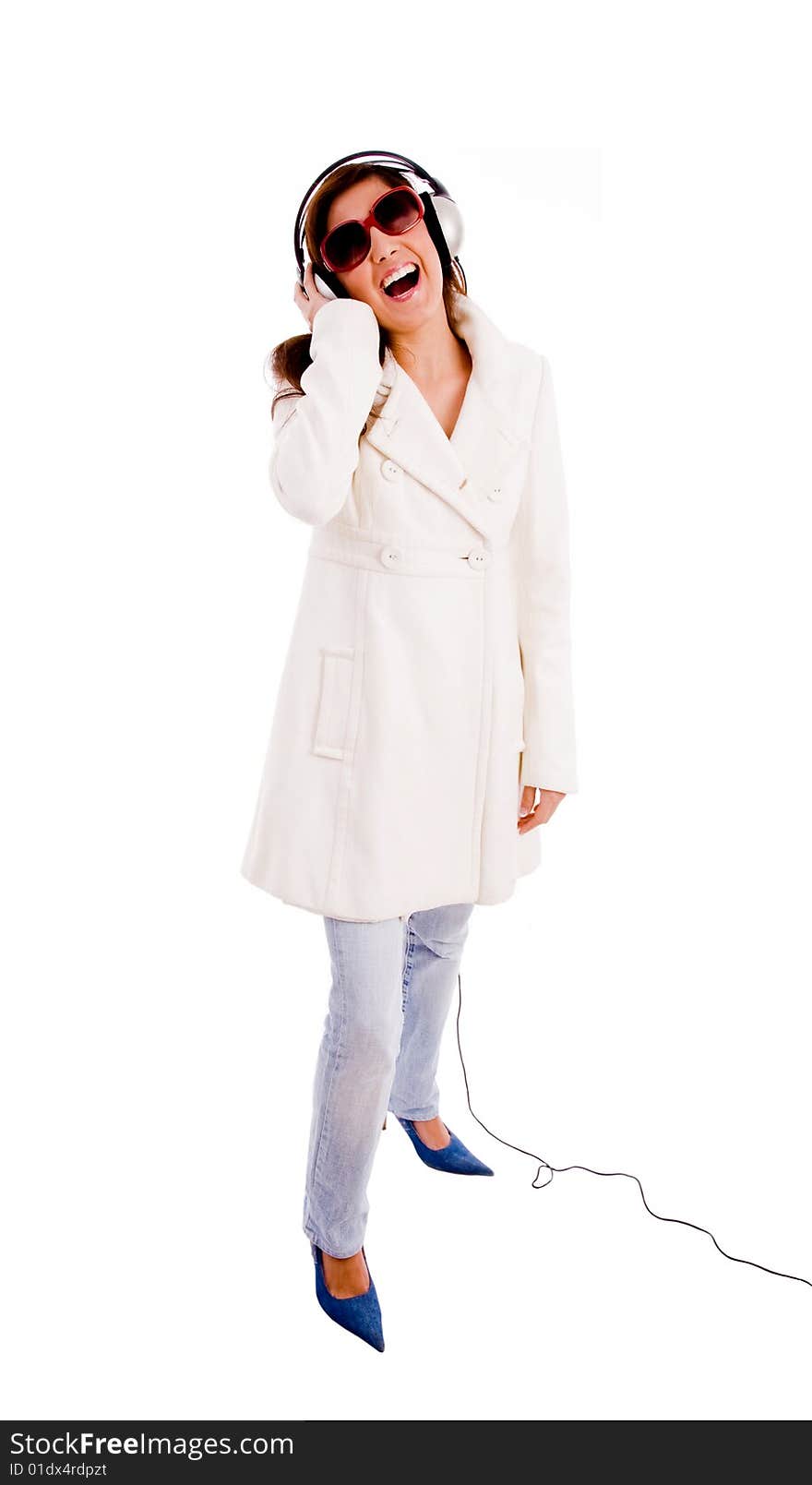 Side pose of standing model enjoying music with white background