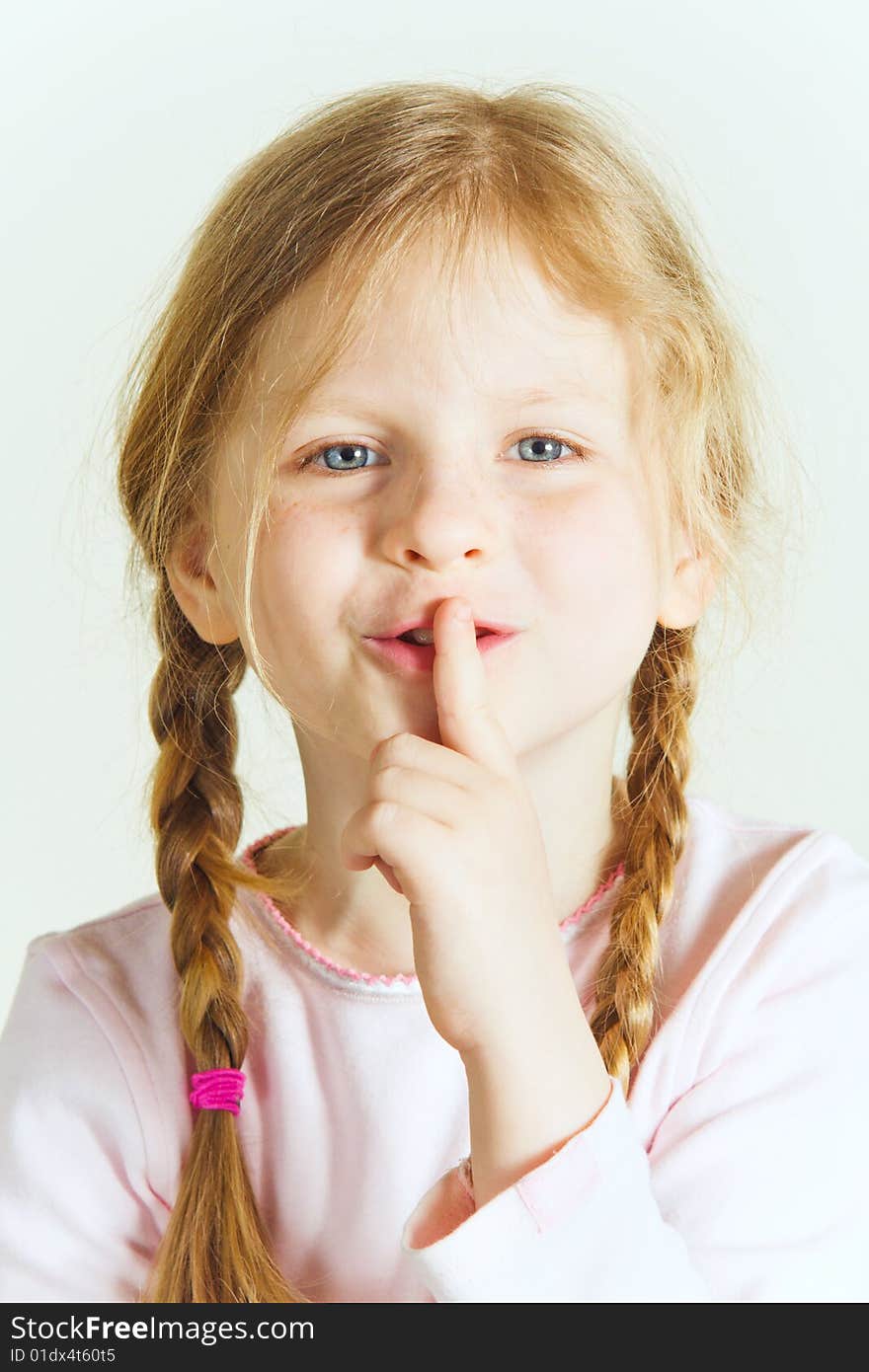 Small girl with a finger at her mouth