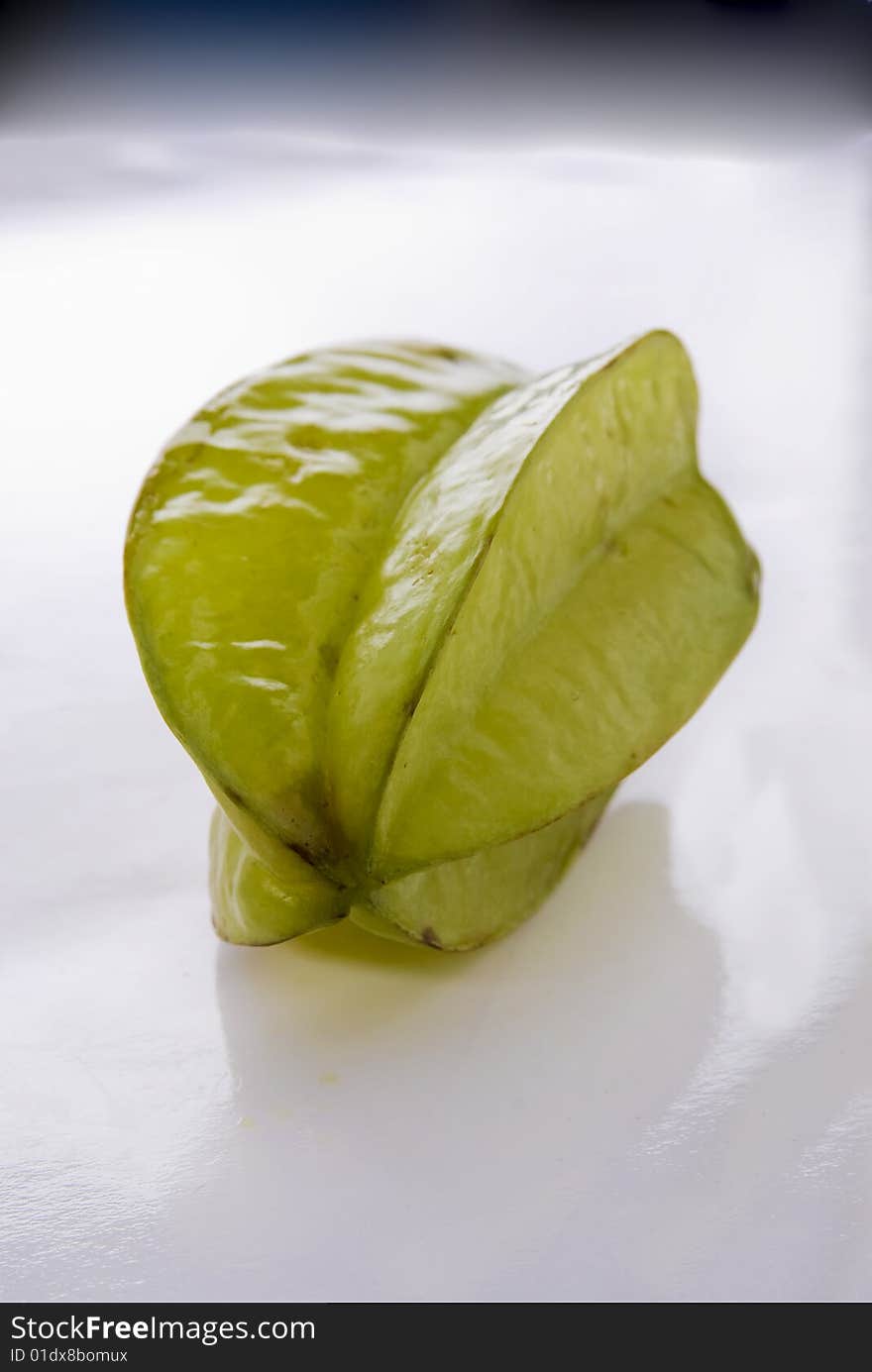 One single star vegetable laying on a white background.