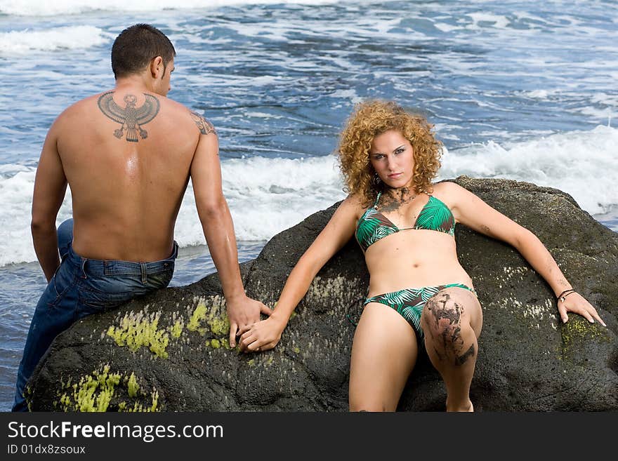 boy and girl lying on her back on the rocks. boy and girl lying on her back on the rocks