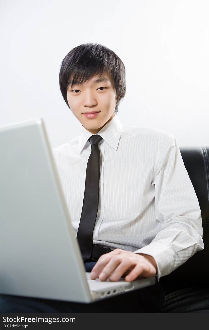 The young man is dressed in a white shirt