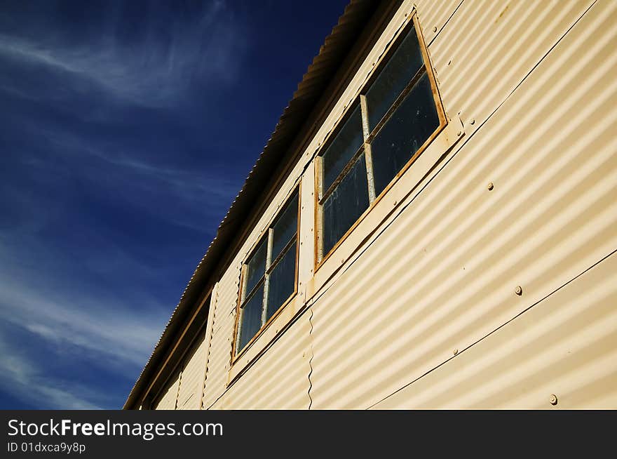 Windows on an old currugated metal building. Windows on an old currugated metal building.