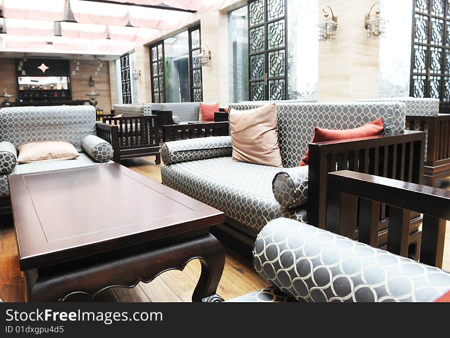 The luxury hotel lobby with sofas and wood tea tables.