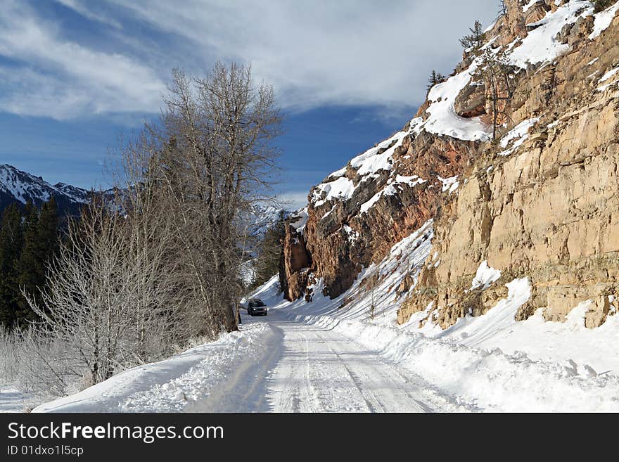 Mountain road in winter with car