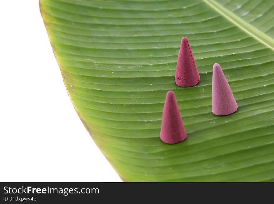 Sandalwood incense cones on banana leaf. Sandalwood incense cones on banana leaf