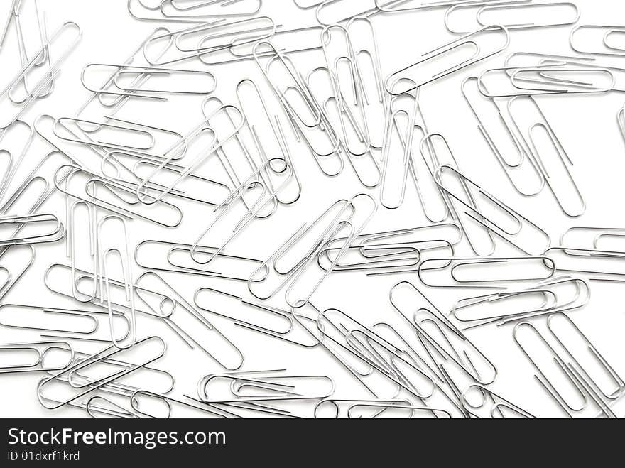 A macro shot of many paperclips on white. A macro shot of many paperclips on white.