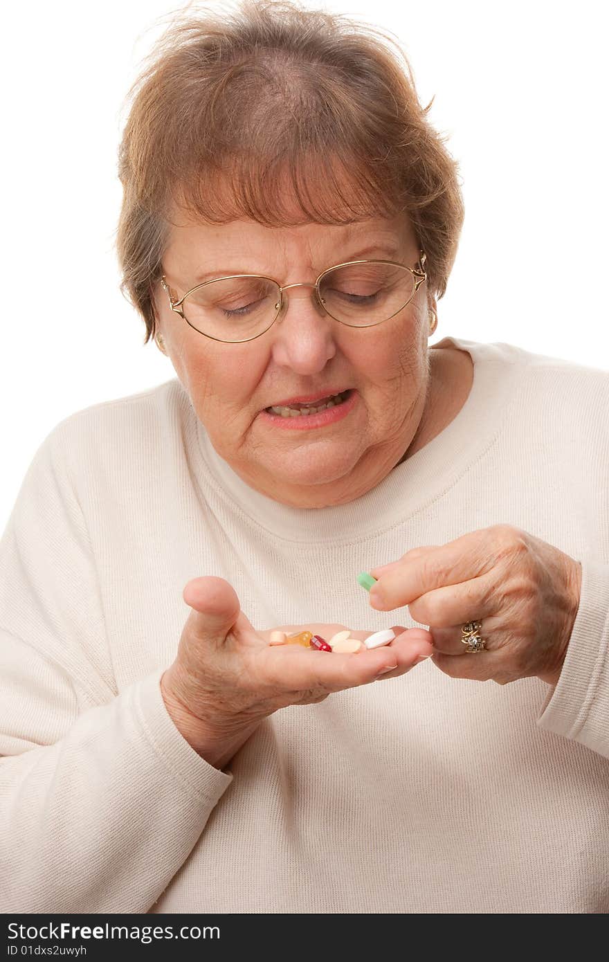 Attractive Senior Woman and Pills Isolated on a White Background.