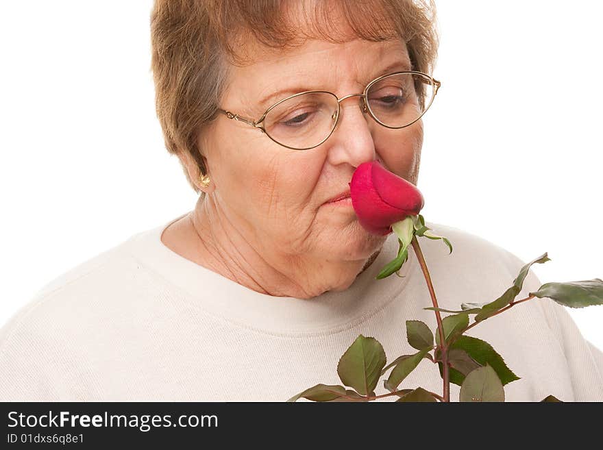 Attractive Senior Woman with Red Rose Isolated on a White Background.