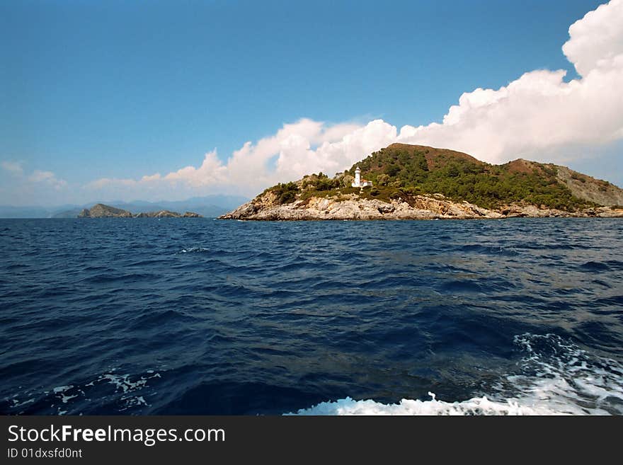 Lighthouse on island at the entrance to Fithie harbour in Turkey