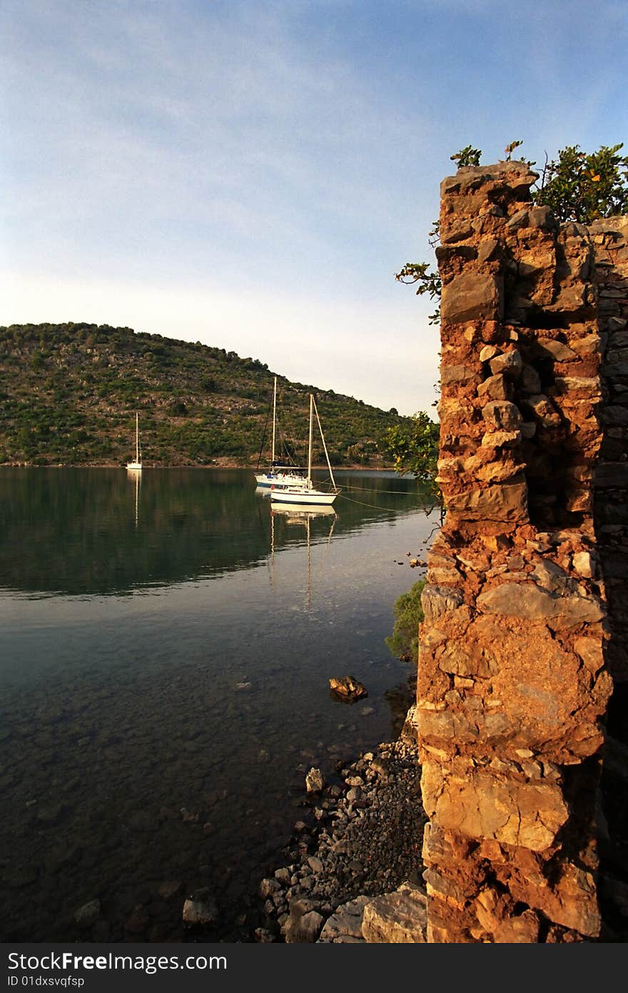 Anchoring yacht at beautiful coast in mediteranian sea near bizantian ruins. Anchoring yacht at beautiful coast in mediteranian sea near bizantian ruins