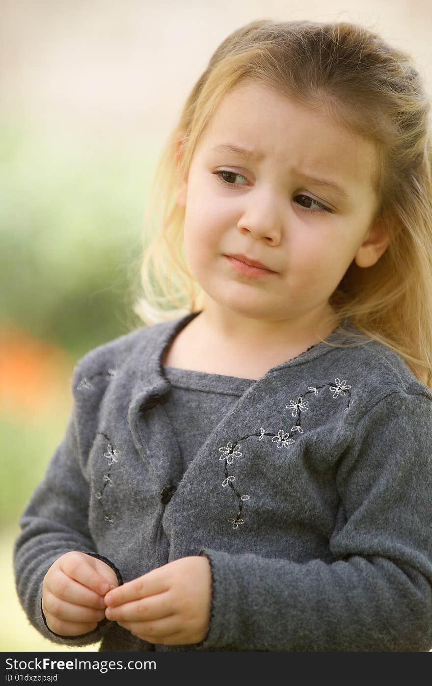 Blonde Little Girl In a Gray Sweater