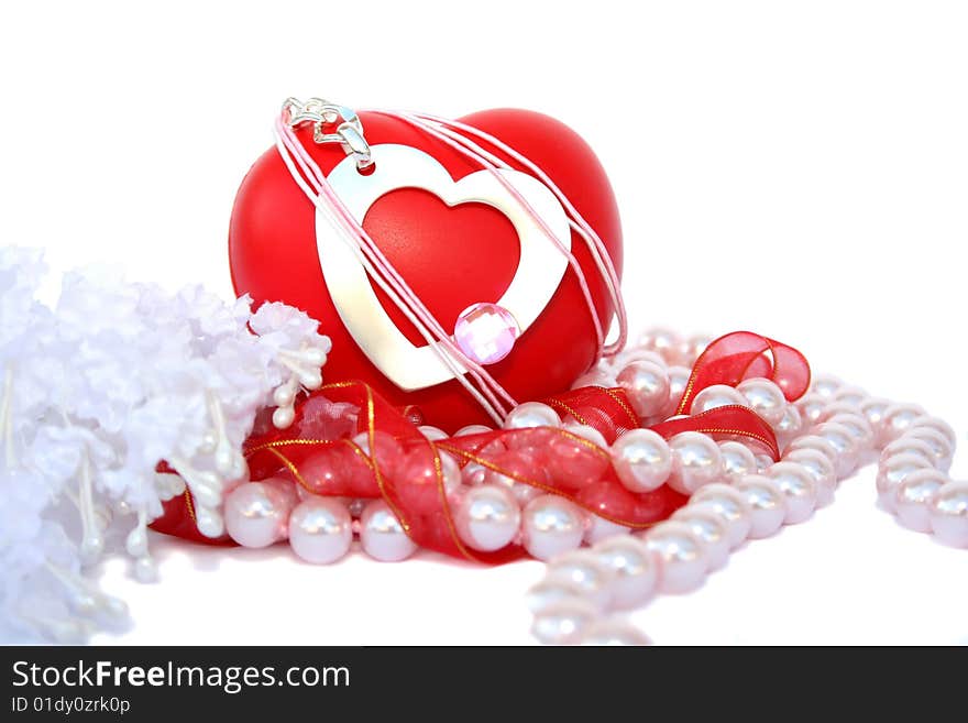 Valentine hearts,red ribbon,pink pearls and fabric flowers on white background.