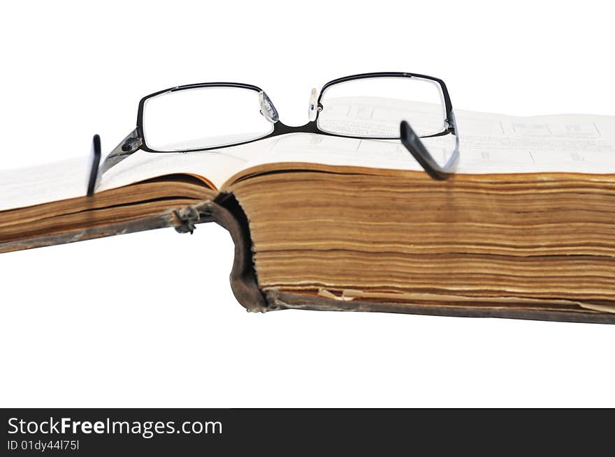 Old large book with glasses