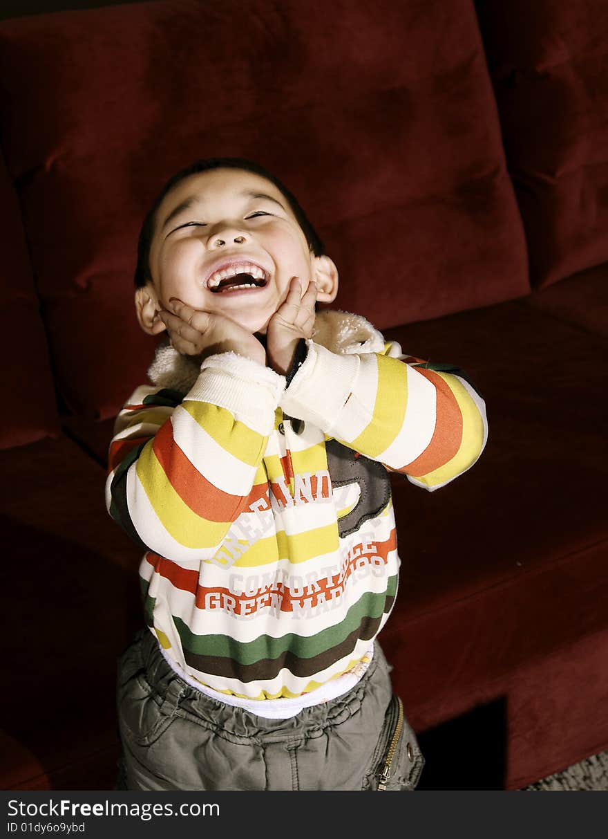 A picture of a chinese little boy laughing and facing upward. A picture of a chinese little boy laughing and facing upward