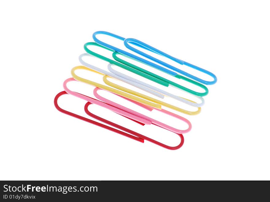 Few colored paper clip on white background close