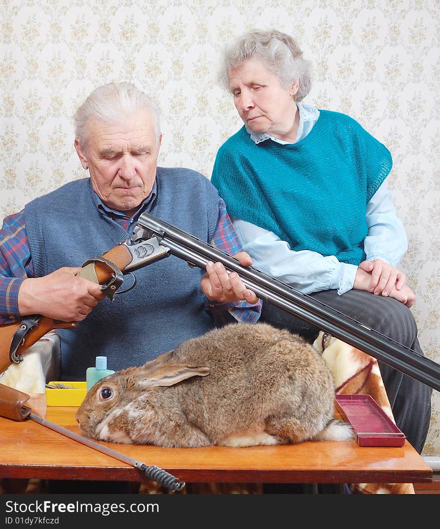 Grandfather load rifle, and grandmother look on it. Grandfather load rifle, and grandmother look on it