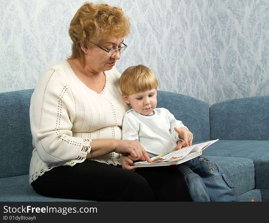 Portrait of the grandmother with the grandson in house conditions