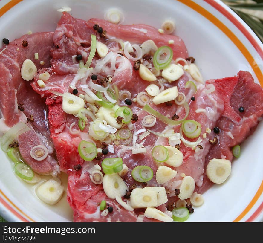 Fresh meat of pork with spring onions and pepper