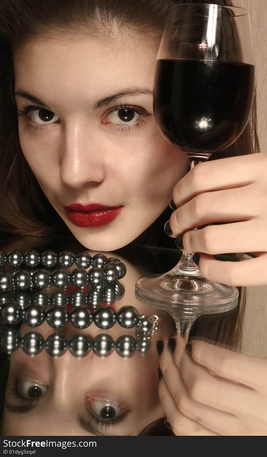 Portrait of the girl with a glass of wine and reflection in a mirror. Portrait of the girl with a glass of wine and reflection in a mirror.