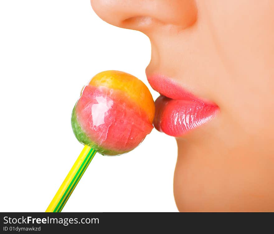 A women with the brightly painted lips eating a lollipop candy. Shallow DOF. A women with the brightly painted lips eating a lollipop candy. Shallow DOF.