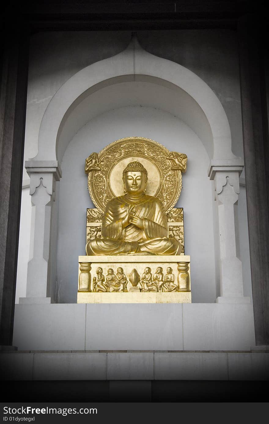 Desaturate and gold statue of buddha in an indian temple. Desaturate and gold statue of buddha in an indian temple