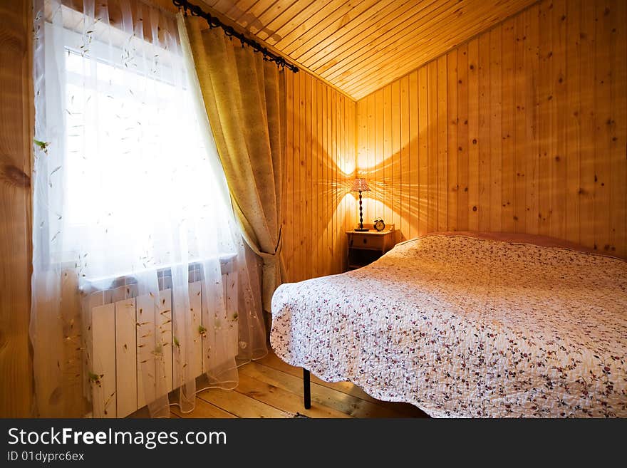 Cosy and wooden bedroom in modern hotel