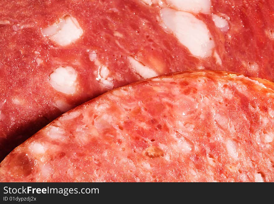 Slices of sausage close up as a background