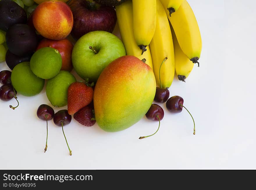 Fresh tropical fruit layed out on a white background