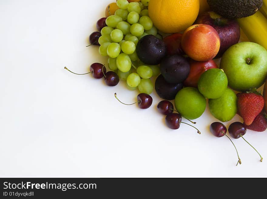 Fresh tropical fruit layed out on a white background