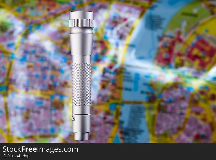 Light concept ï¿½ flashlight over blurred map