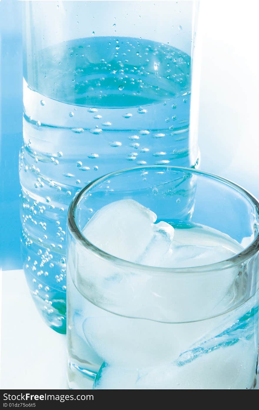 Plastic bottle and glass with pure water.