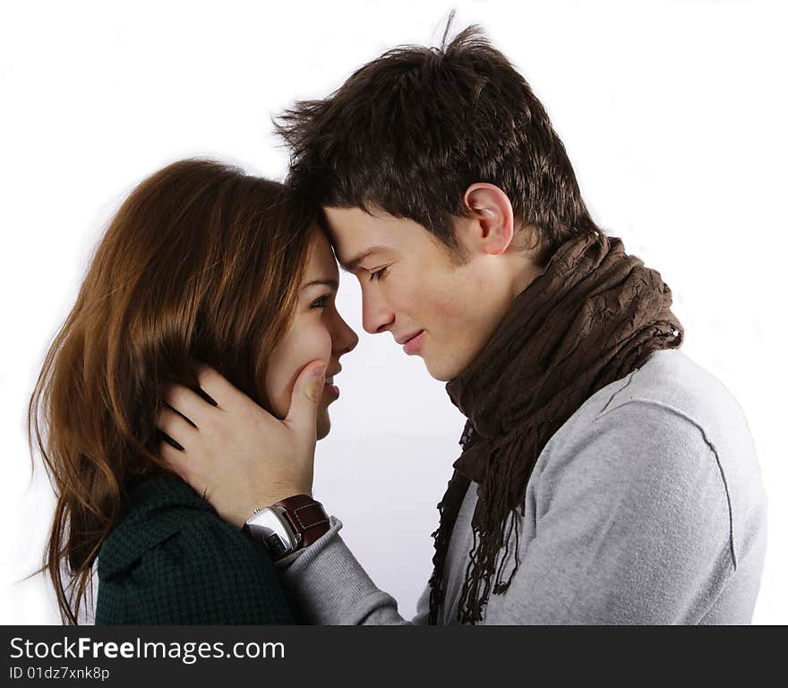 Young attractive couple looking into each other's eye isolated on white. Young attractive couple looking into each other's eye isolated on white