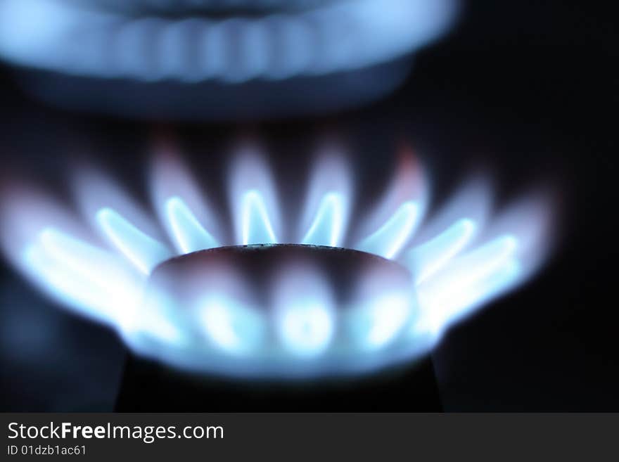 Close-up of burned gas range on dark background