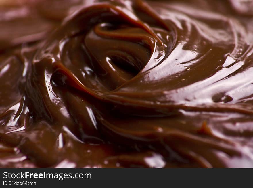 Macro of liquid chocolate making irresistible waves. Macro of liquid chocolate making irresistible waves.